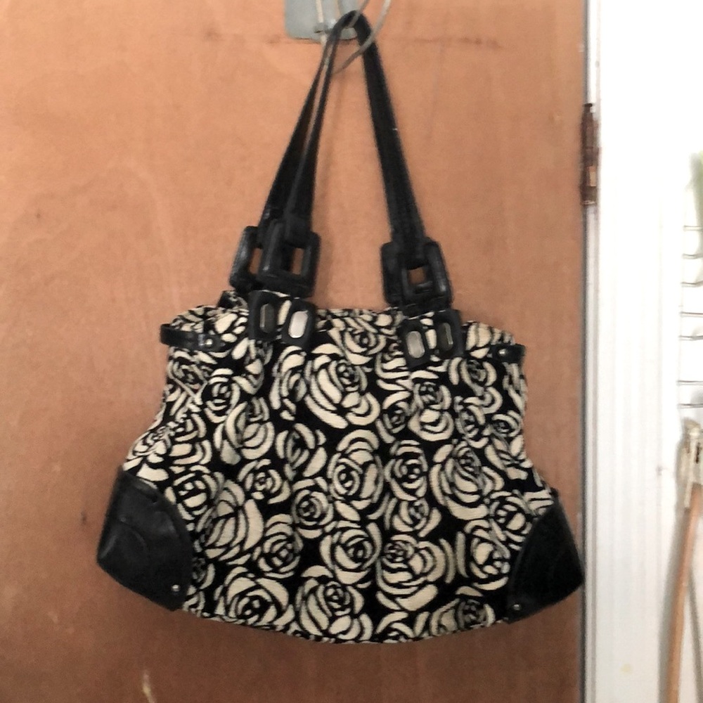 This is a rose flower black and white bag with three inside sections